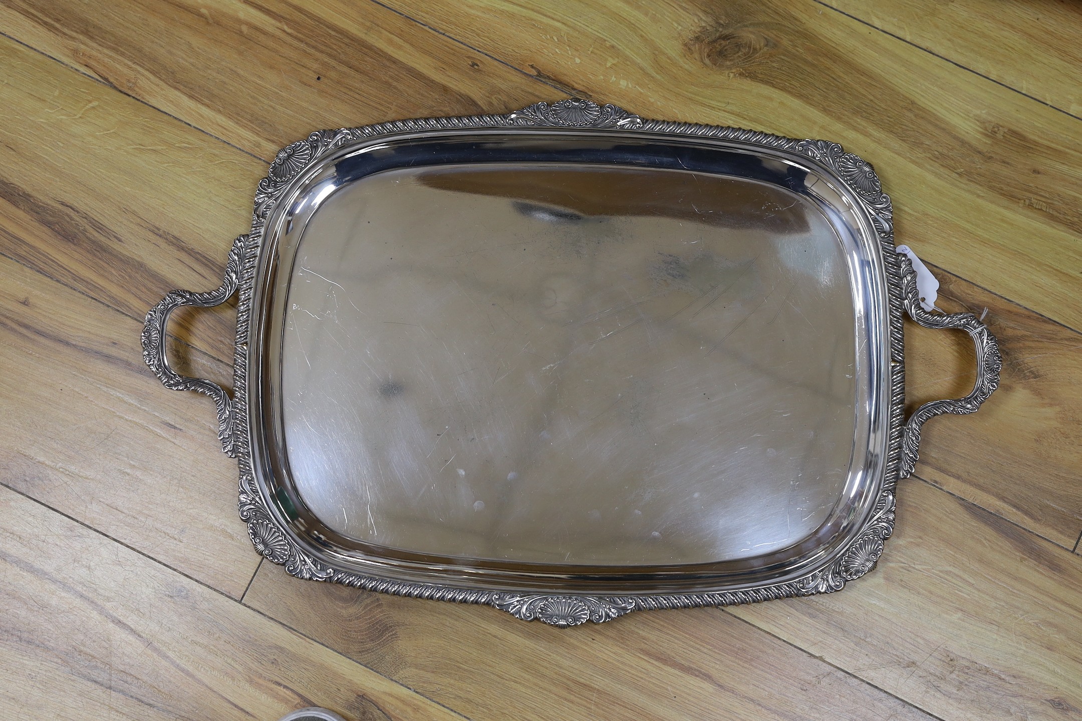 A large silver plated two handled tray and a similar salver, tray 65 cms wide